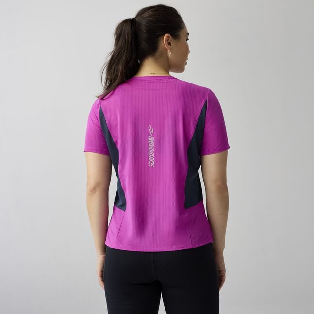 Woman wearing brooks high point short sleeve 2.0 running shirt purple with brooks branding