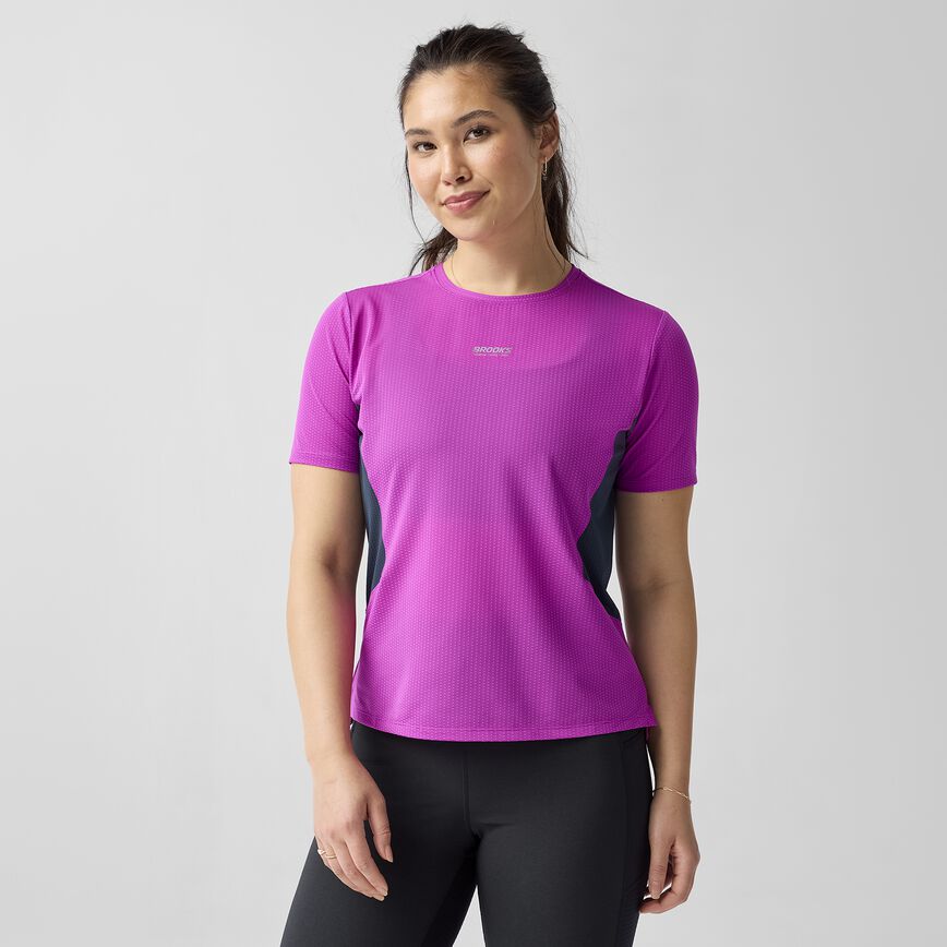 Woman wearing brooks high point short sleeve 2.0 running shirt purple with brooks branding