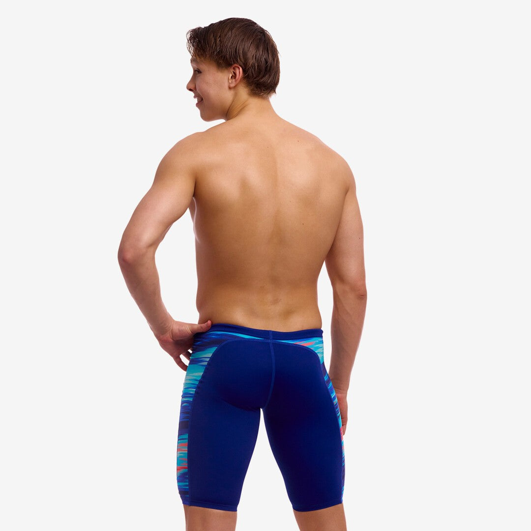 man wearing funky trunks jammers, storm at sea pattern, back view