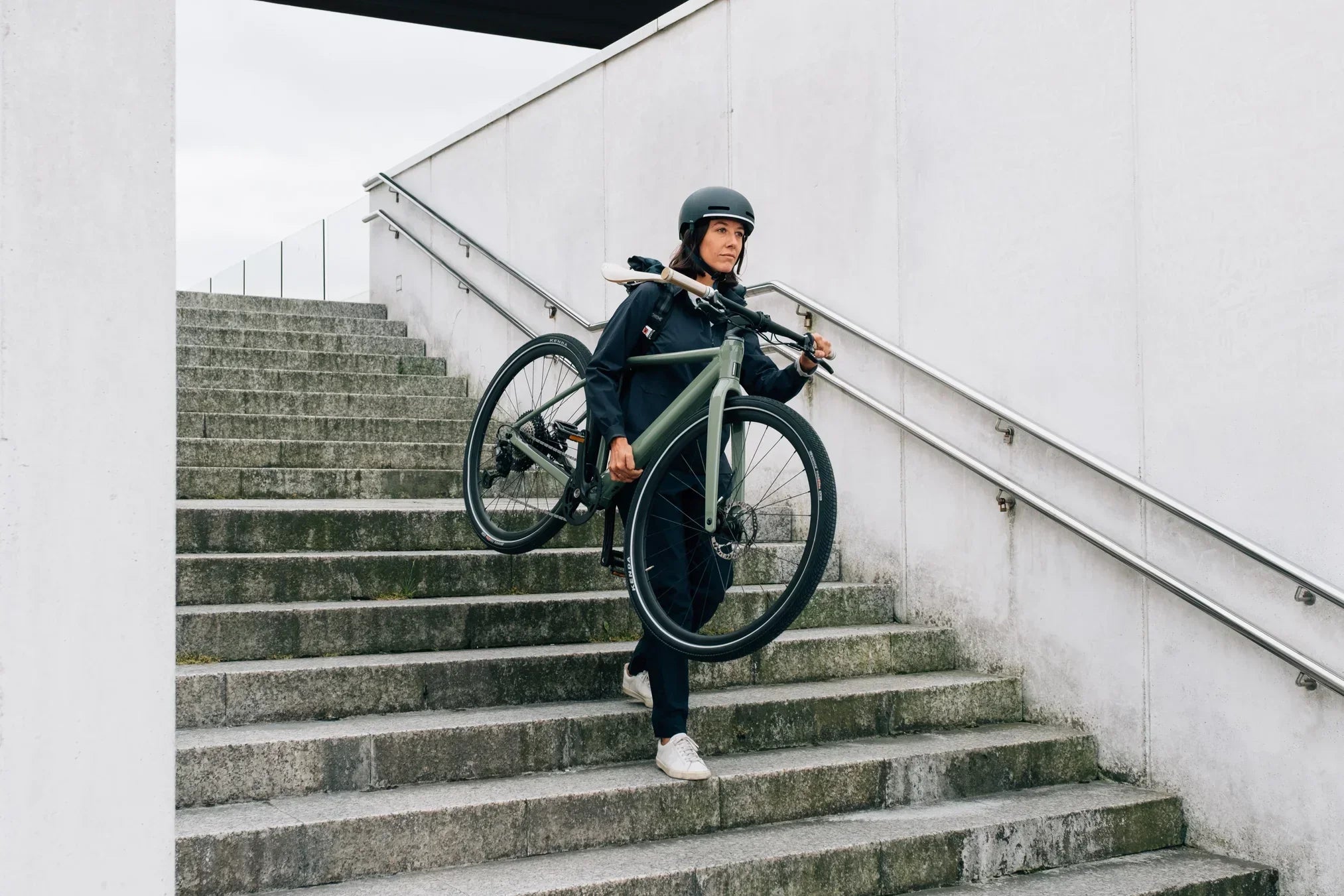 woman carrying an orbea bike to work, bike to work scheme