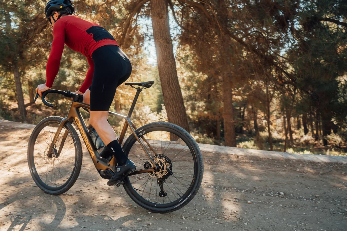 man cycling on a mountain path on an orbea denna gravel bike