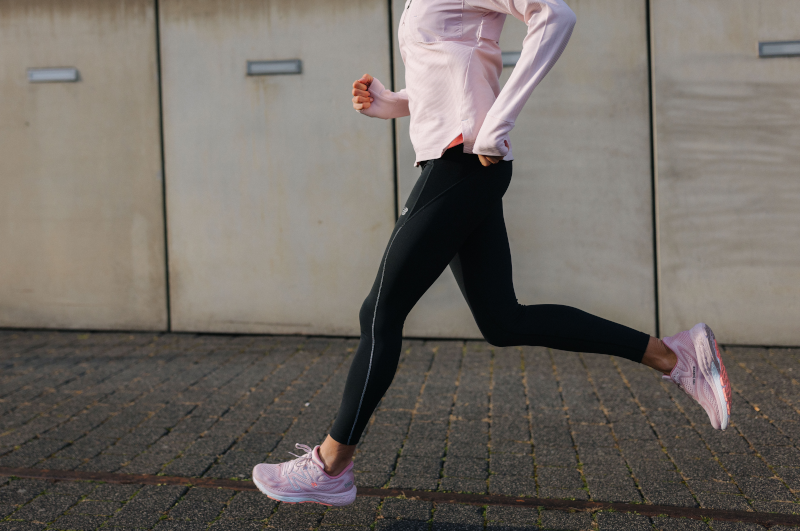 woman running in new balance running shoes