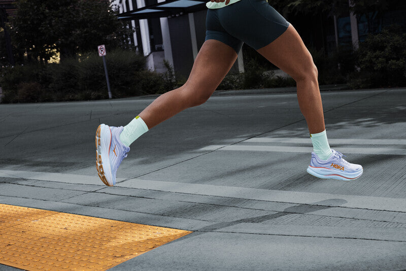 woman running in Hoka cushioned running shoe
