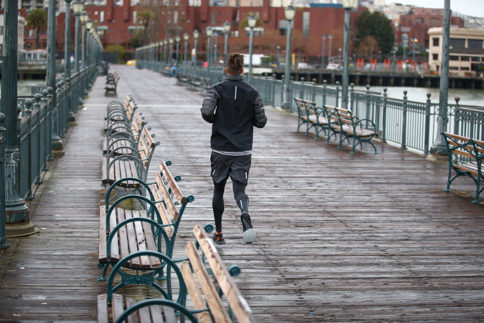 man running in new balance run clothing