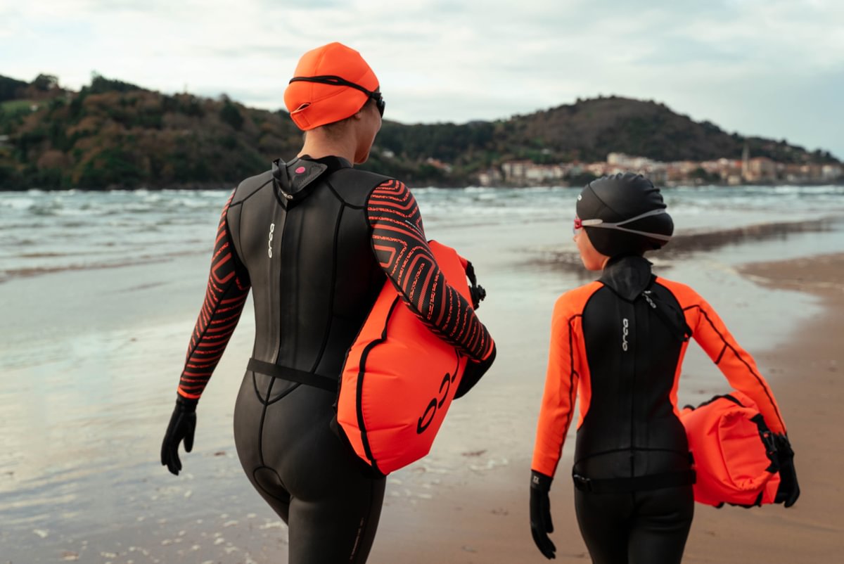 orca swim caps and tow floats, orca wetsuit on woman and child