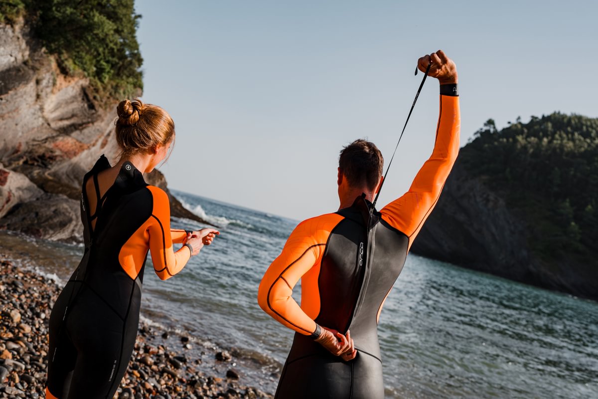 Orca wetsuits for men and women at The Sports Room. Couple wearing Orca Vitalis hivis