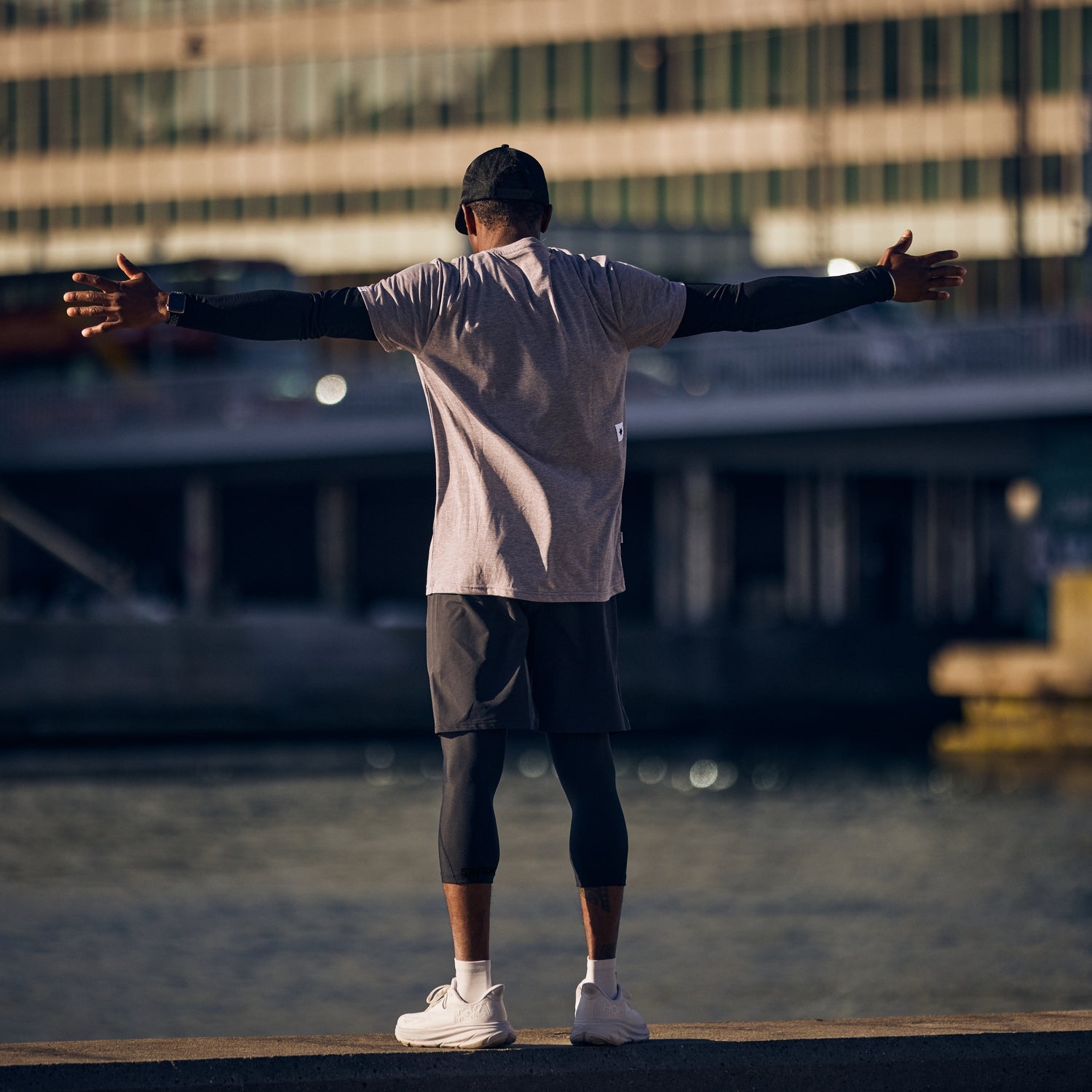 Man resting during run wearing high performance white run tee