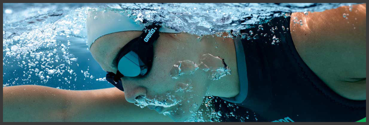 woman swimming wearing arena goggles, buy arena swim gear at the sports room wicklow
