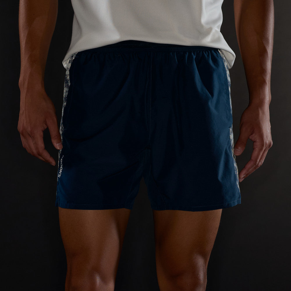 Man wearing Brooks Dash Reflective Shorts, showing how side panels glow in the dark