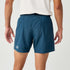 Man wearing Brooks Dash Reflective Shorts, showing back and back zip pocket, logo near hem