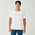 Man wearing Brooks Reflective Dash Tshirt in cream colour with reflective writing