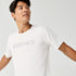 Man wearing Brooks Reflective Dash Tshirt in cream colour with reflective writing