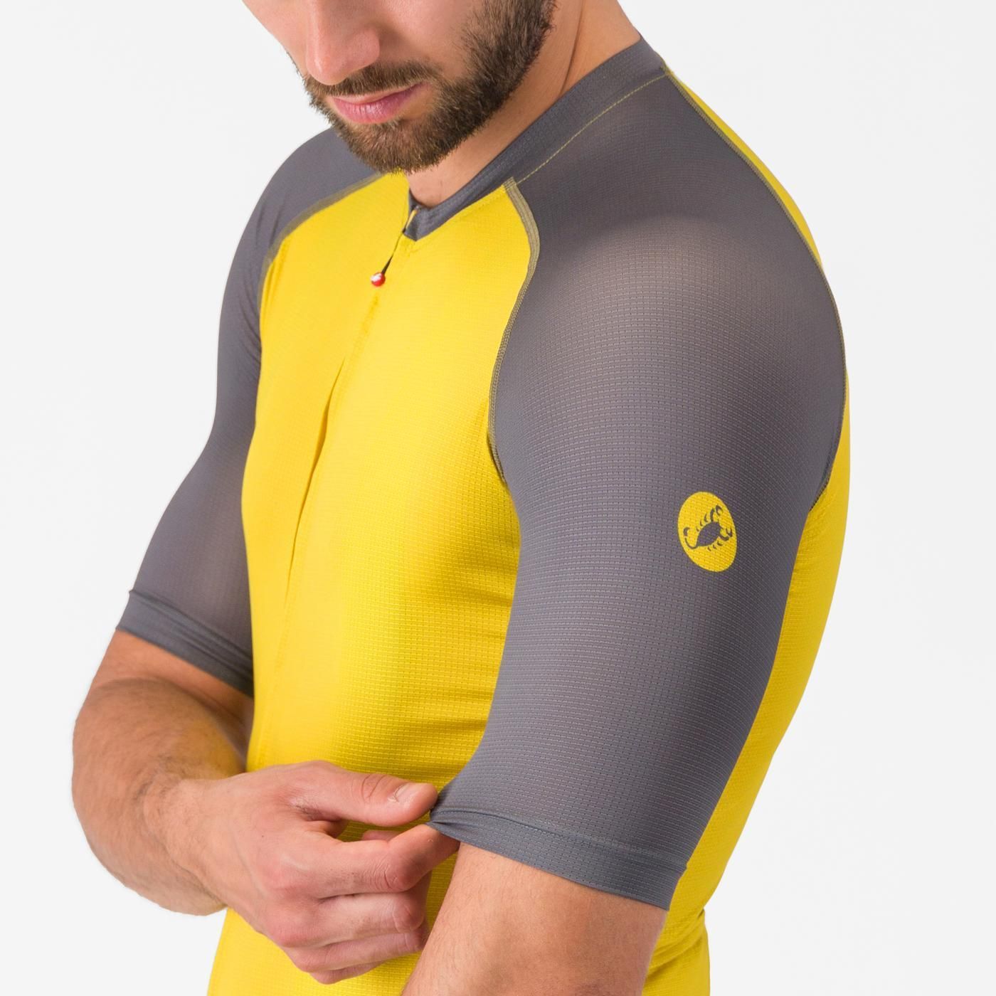 Man wearing Castelli Unlimited Endurance 3 Cycling Jersey in grey and yellow, focus on stretch on sleeve