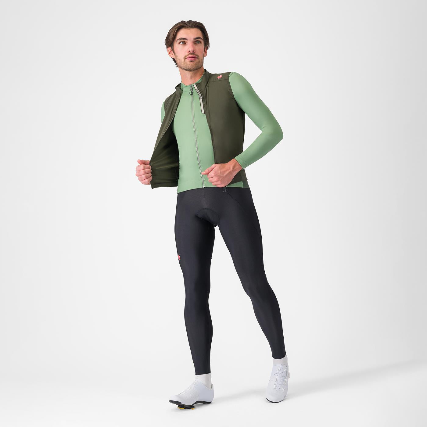 man wearing castelli espresso vest for wind protection while cycling, dark green colour, zip open