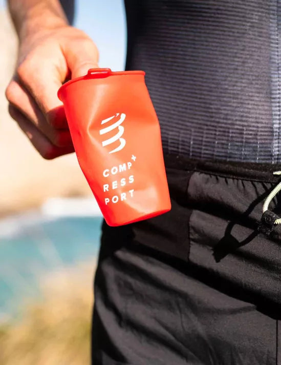 Soft reusable compressport fast cup in red colour in hand racing