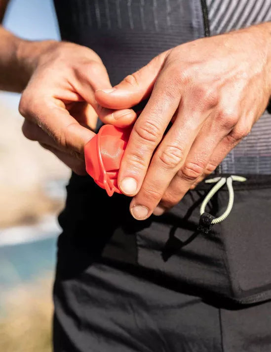 Soft reusable compressport fast cup in red colour collapsed in hand