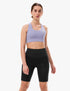 Woman wearing a lavender compressport sports bra and shorts with small logo in corner