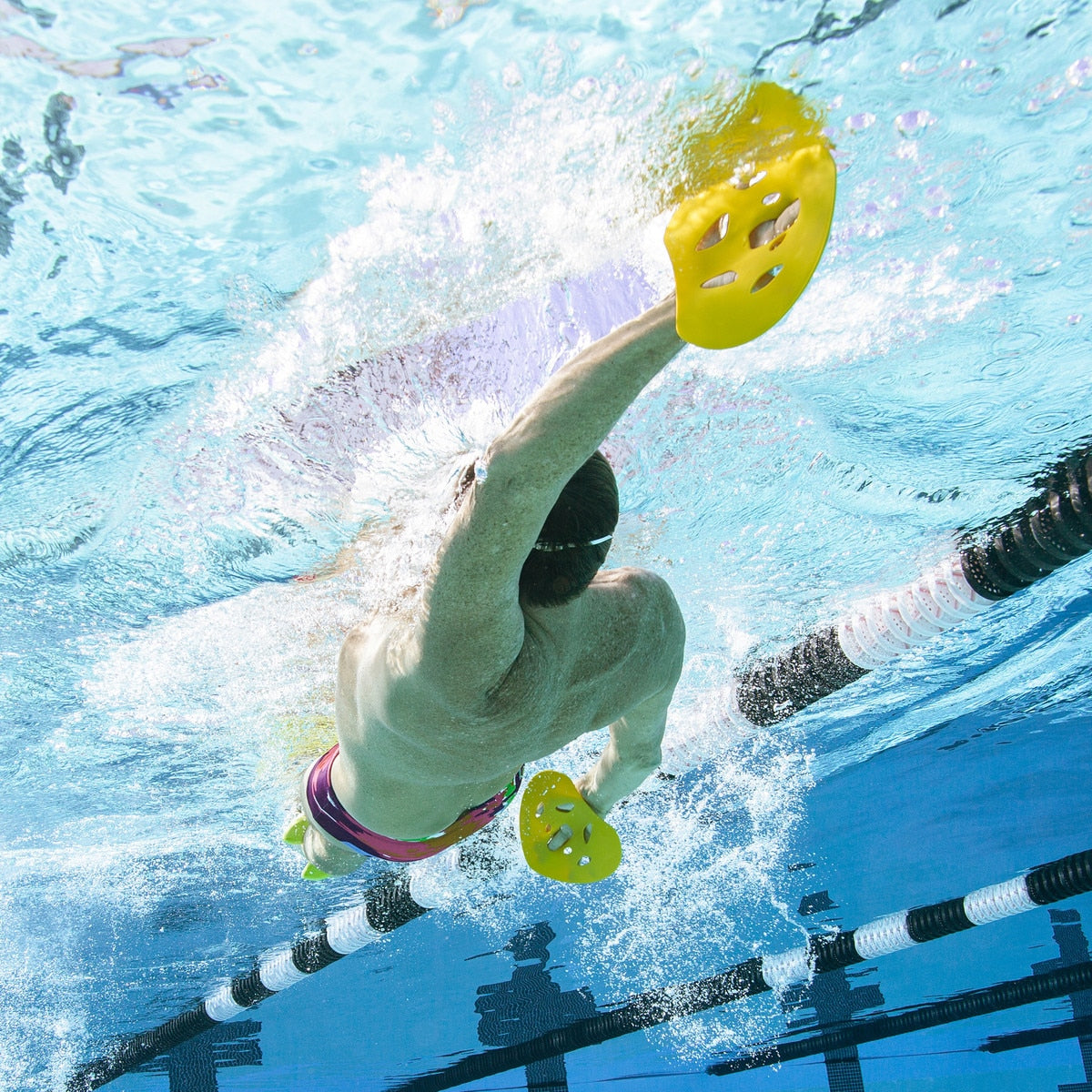 Man swimming back stroke with finis manta paddle