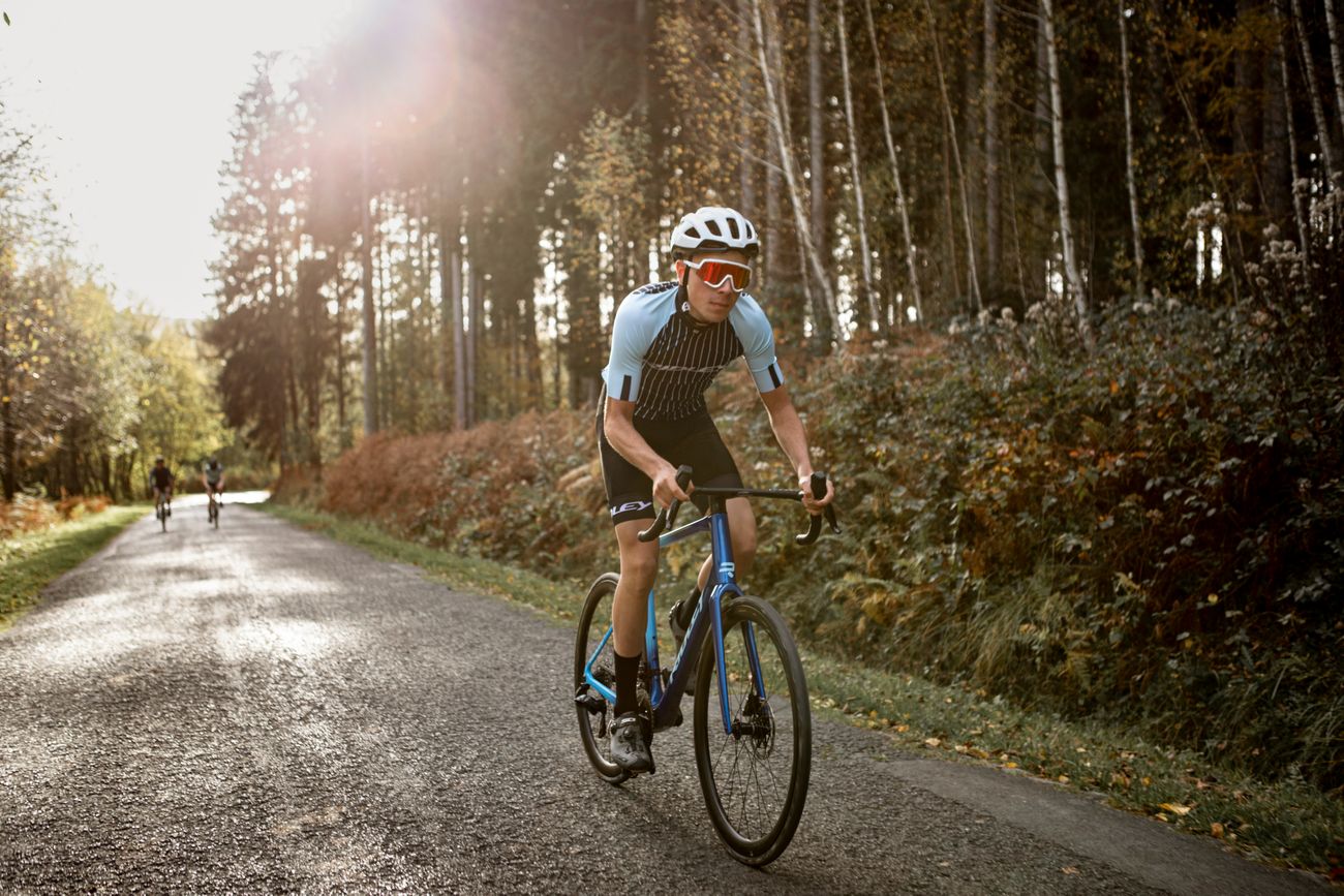 man riding on the roads near the forest on a ridley grifn bike