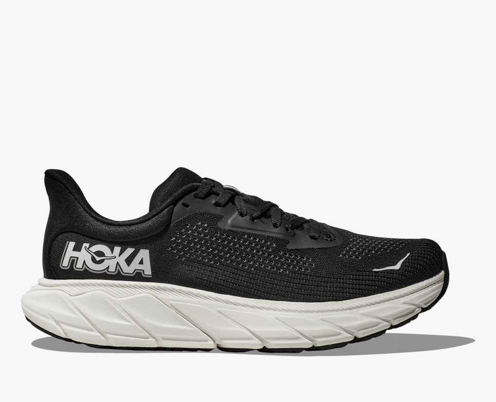 Black hoka arahi 7 running shoe with white sole on a white background