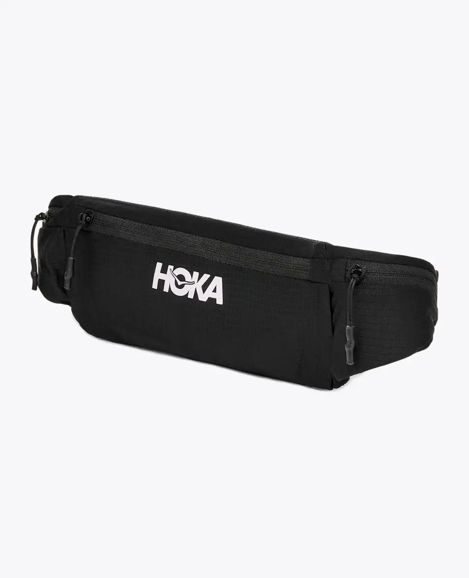 hoka running belt, running belt with zipper storage pockets, black colour with reflective logo, front of belt bag