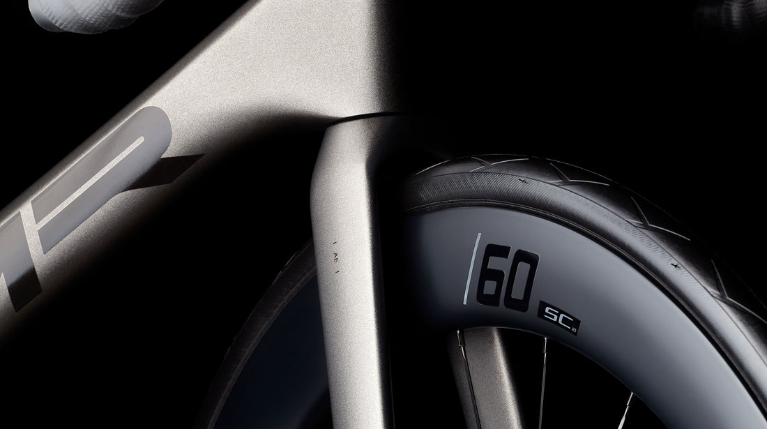 Close-up of a bicycle wheel oon an MMR Aelion 30 with a display showing '60 SC'.