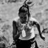 woman drinking maurten additions from soft flask whilst running 