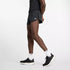 Person wearing black New Balance Men's RC Split Short 3"athletic shorts with a brand logo on a white background