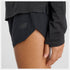 woman wearing NB athletics long sleeve run top in black, showing close up of pin dot mesh and thumbholes