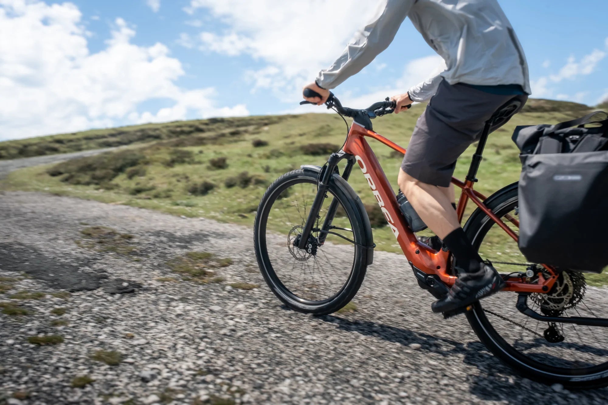 man cycling an orbea kemen ebike on a fire road