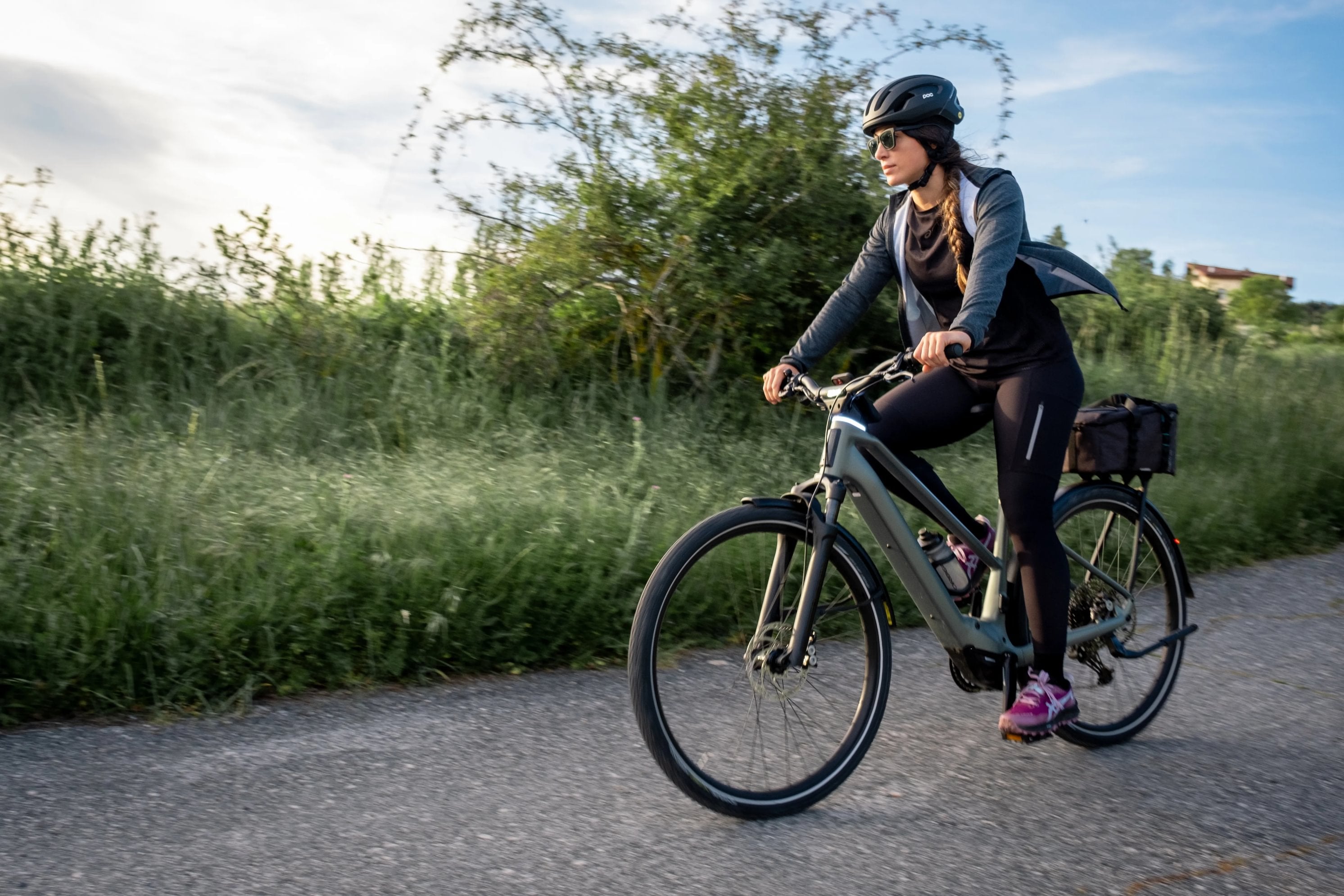 Woman cycling orbea kemen tour electric bike on country roads