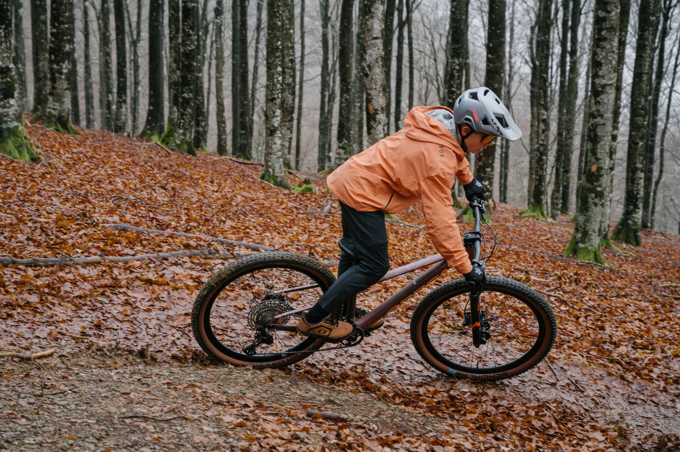 Child riding orbea kimu bike in the woods, on the trails