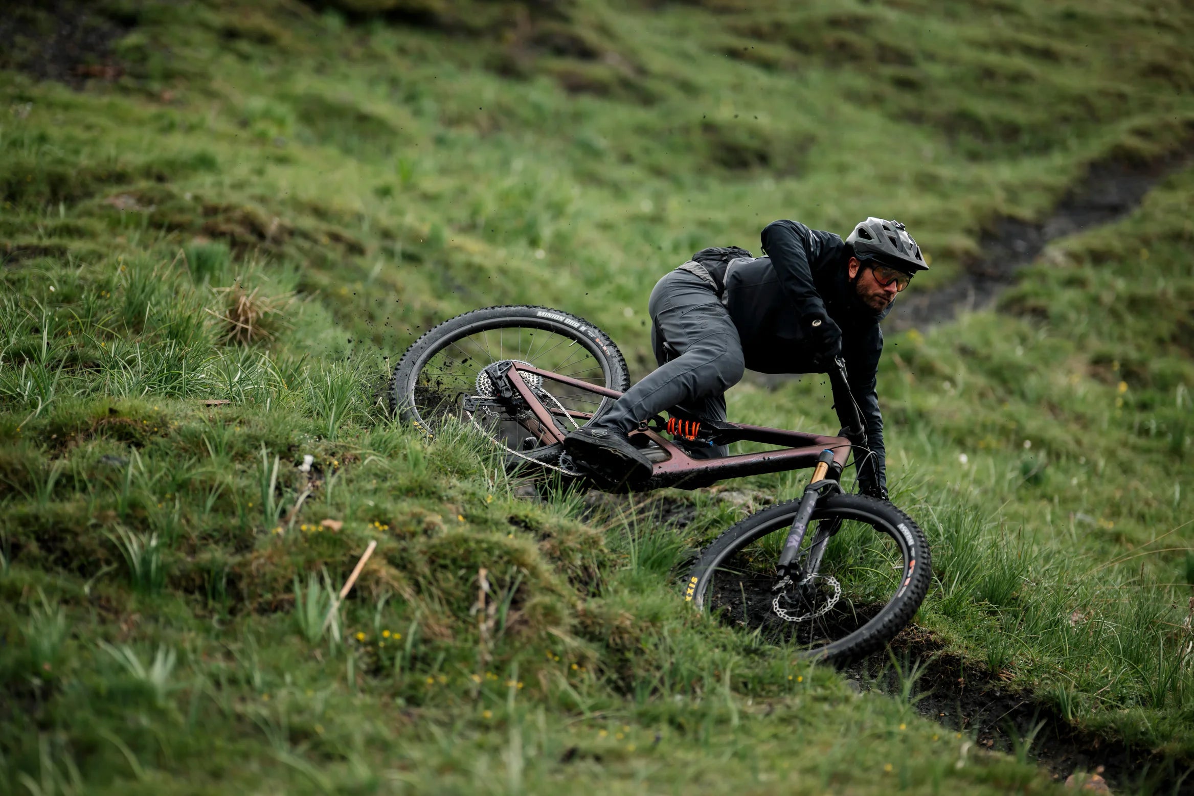 Man mountain biking on a trail on an orbea occam LT