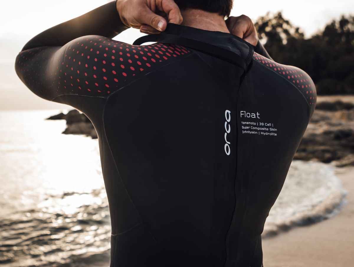 man preparing to sea swim in Orca Athlex Float Triathlon wetsuit for men who need extra buoyancy in legs