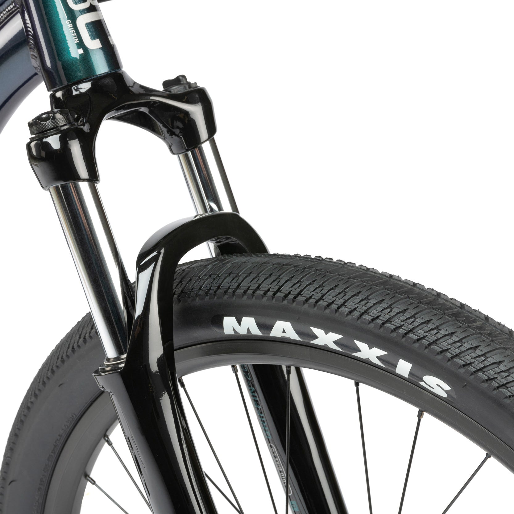 Green dirt jumper from the Radio Bike Company, close up of wheel and maxxis tyre