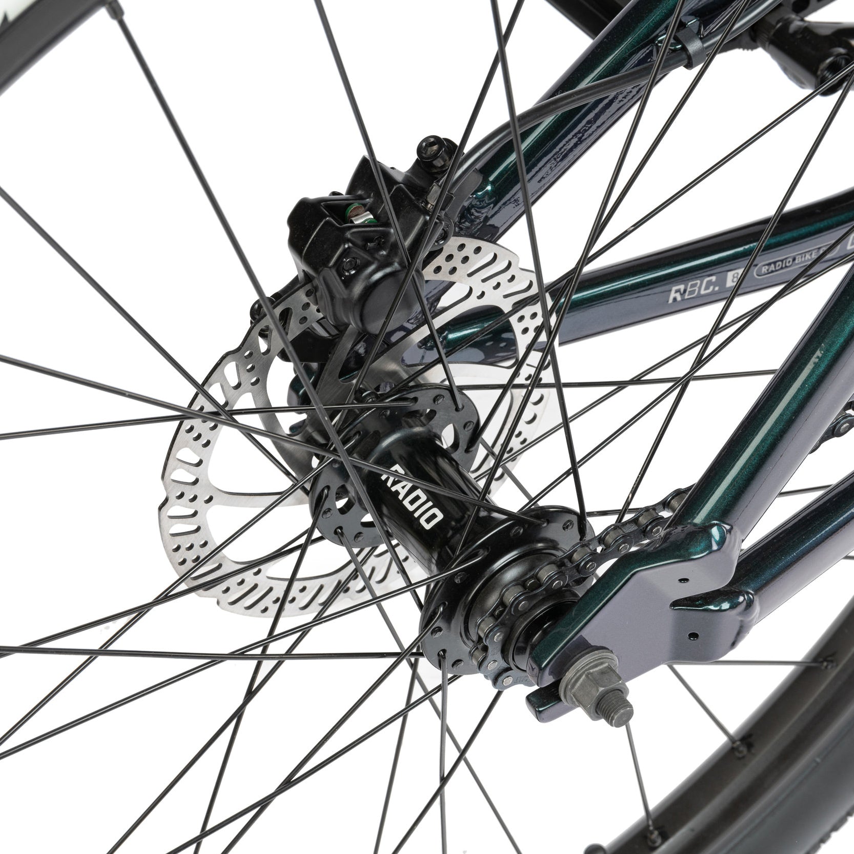 Green dirt jumper from the Radio Bike Company, close-up of a bicycle wheel with disc brake and hub gear 