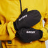 Model wearing pair of black saysky thermal blaze mittens with yellow saysky jacket 