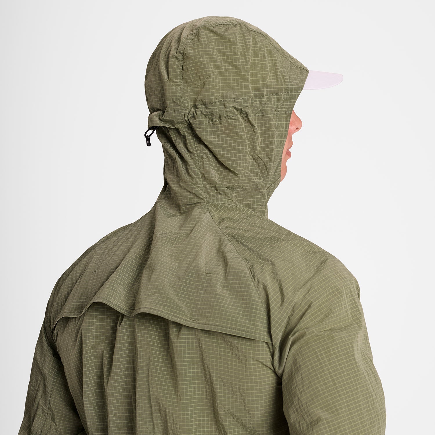 Man wearing SAYSKY clean hooded jacket for road running in beige colour with hood up