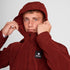 Man wearing SAYSKY clean hooded jacket for road running in red colour showing hood up