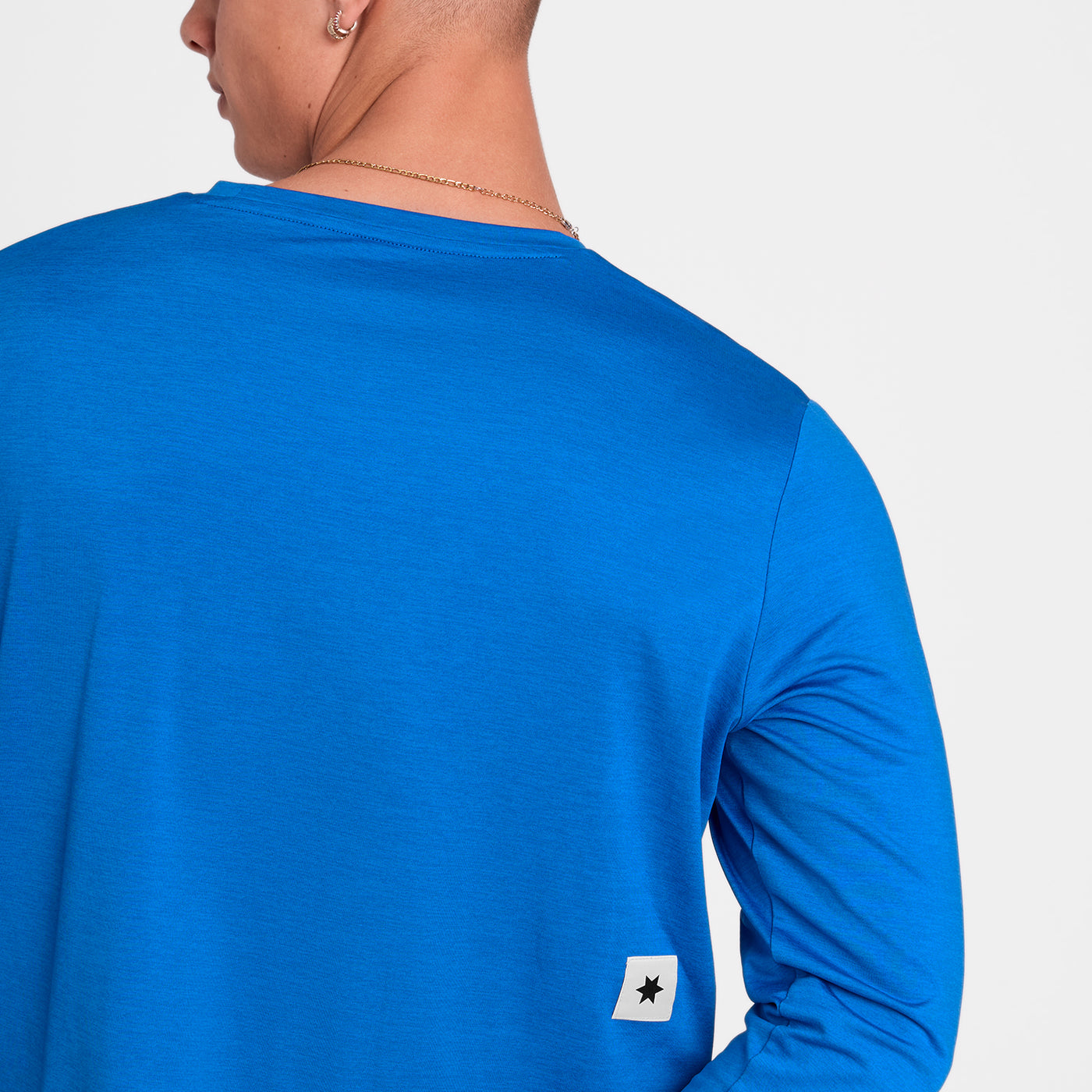Man wearing SAYSKY Clean Pace long sleeve run top in blue