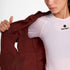 Woman wearing SAYSKY Clean Pace Shield Running Jacket in red colour, showing underarm ventilation