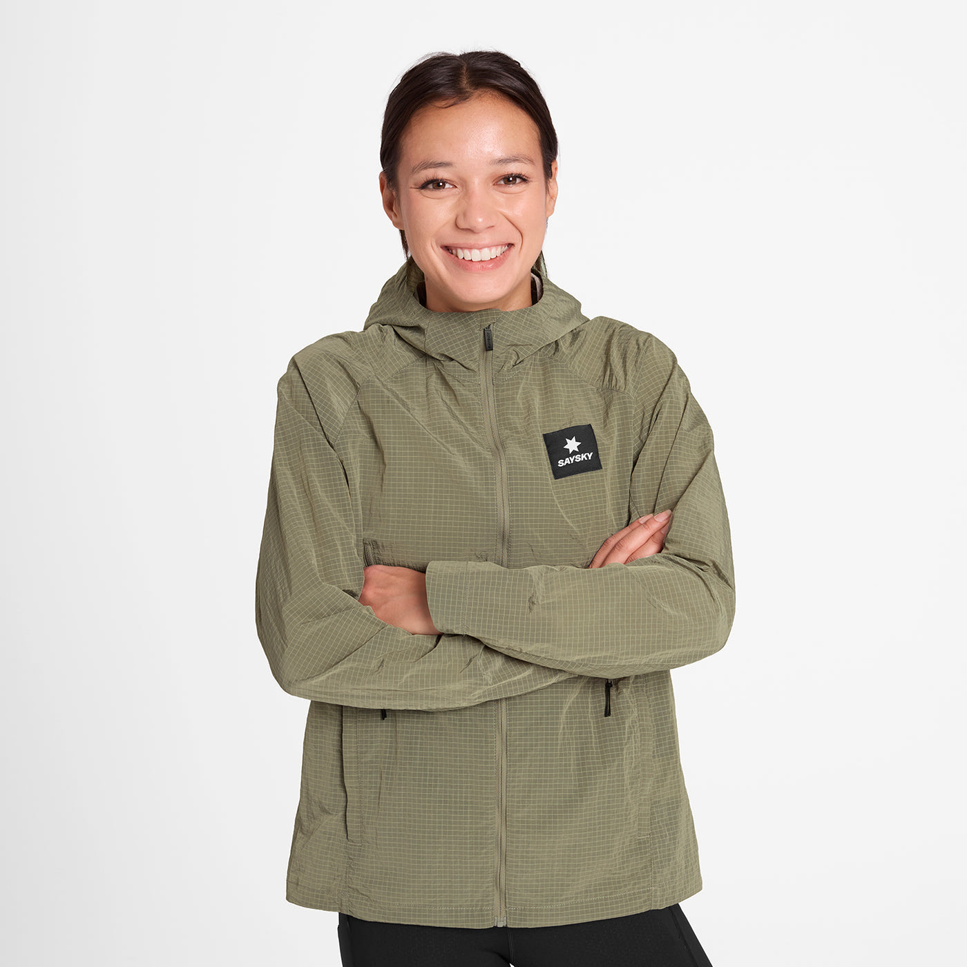 woman wearing SAYSKY running jacket in beige colour
