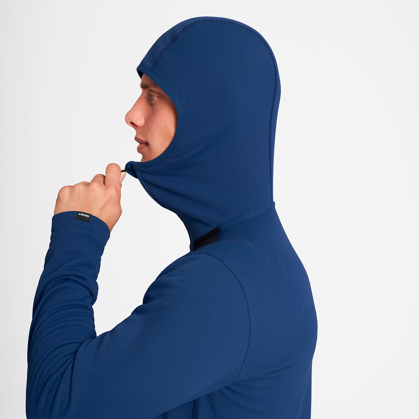 man wearing SAYSKY long sleeve, blue and black, fleece run top with hood up