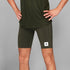 man wearing SAYSKY combat 9 inch run shorts in green, close up of logo