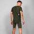 man wearing SAYSKY combat 9 inch run shorts in green with SAYSKY run tee