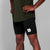 man wearing SAYSKY combat 9 inch run shorts in black, close up of logo