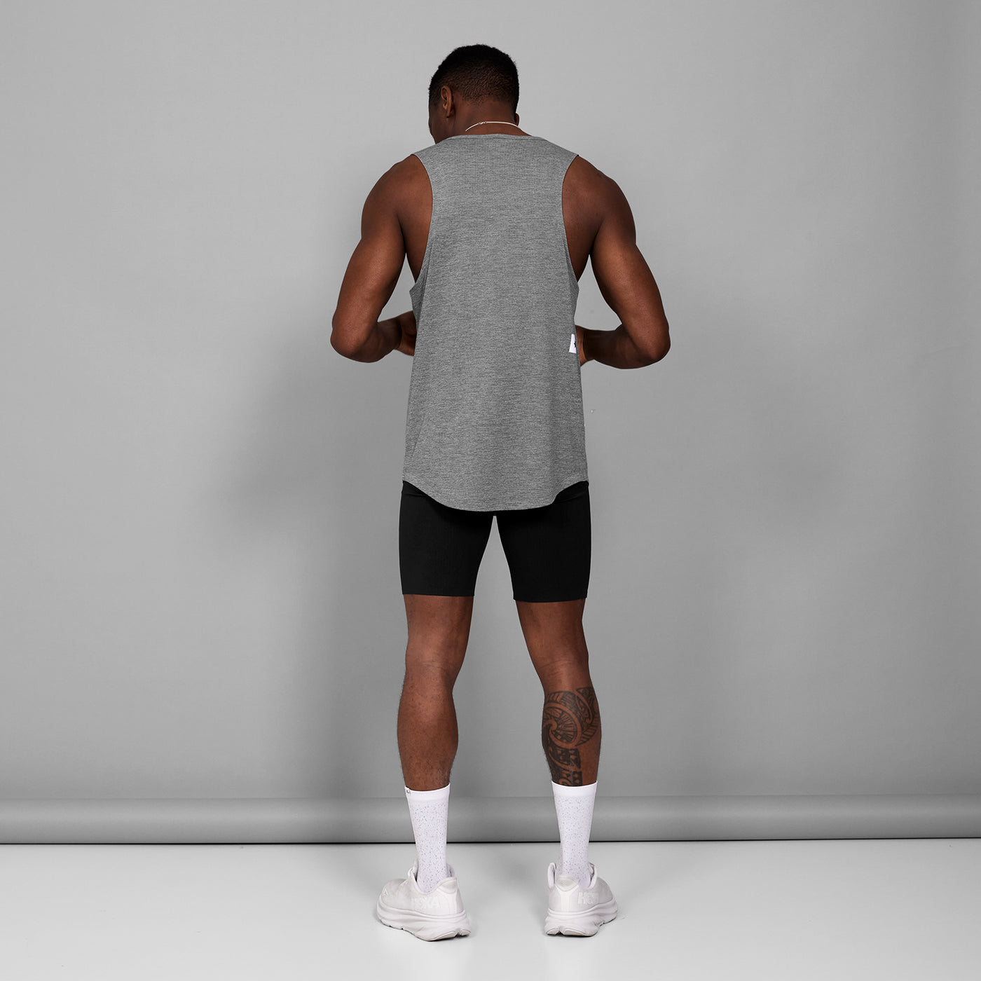 man wearing SAYSKY combat 9 inch run shorts in black, back view