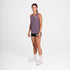 Woman wearing purple saysky run tank, reactive flow singlet