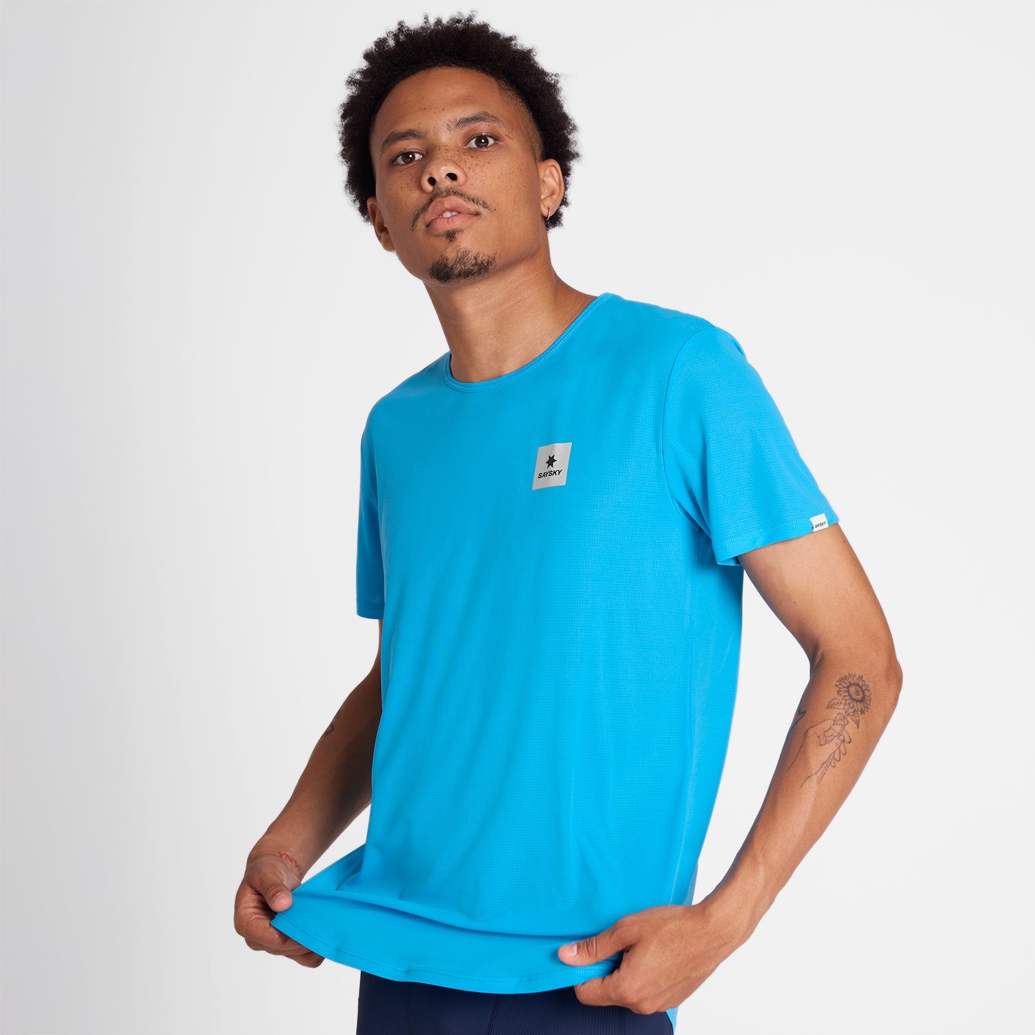 Man wearing a blue SAYSKY running t-shirt with a small logo on front chest