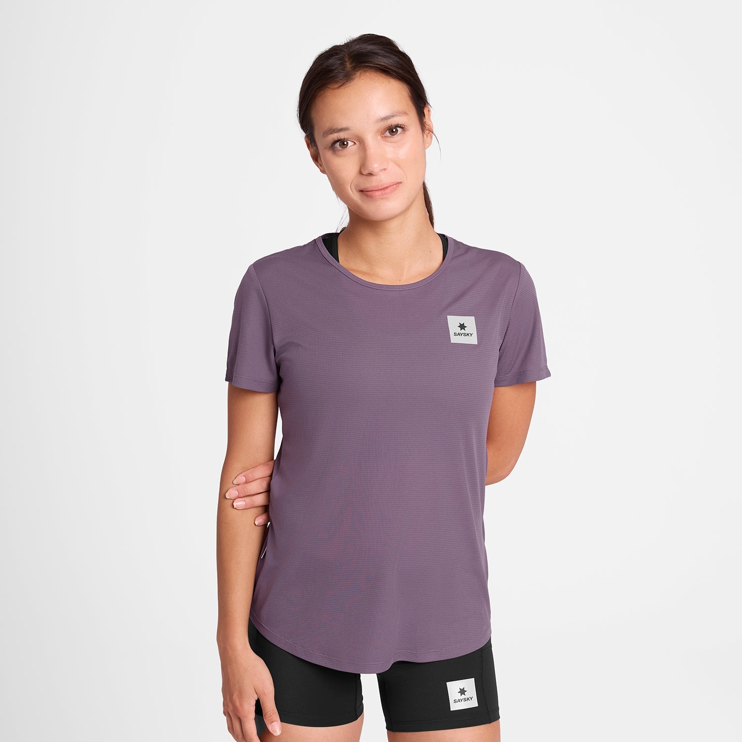 Woman wearing SAYSKY reactive lightweight women's run tee, purple colour